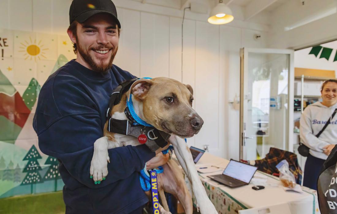 Adventure buddy program volunteer holding Wonderboy the dog