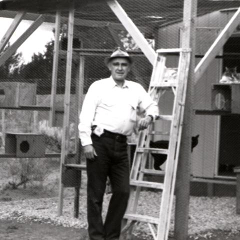 John Fripp beside construction of a cat enclosure
