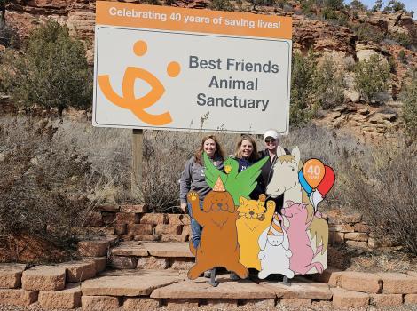 Rochelle and two others at the Best Friends sign by the Welcome Center