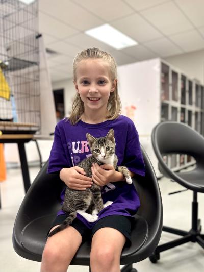 Clara holding Sarah the kitten during the adoption