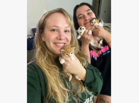Emilie and Haley holding a litter of kittens