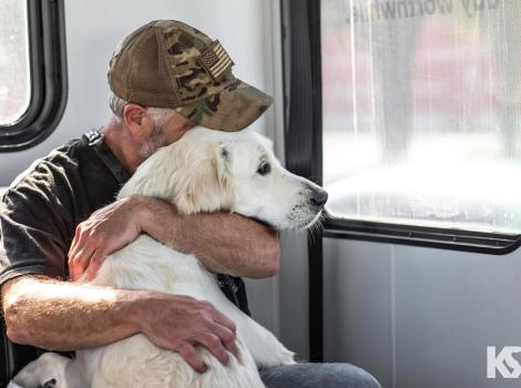 Veteran hugging his dog courtesy of K9s for Warriors