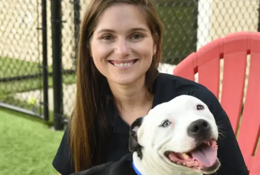 Photo of Leah Backo with white dog
